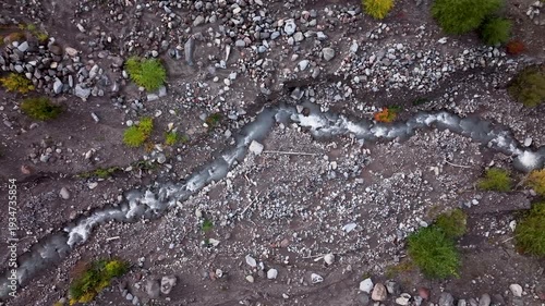 Aerial drone clip over and evergreen forest and river in the American West.