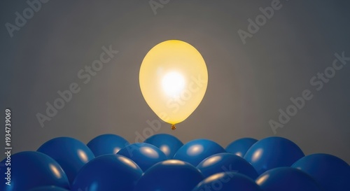 Floating yellow balloon above a group of blue balloons on a neutral background