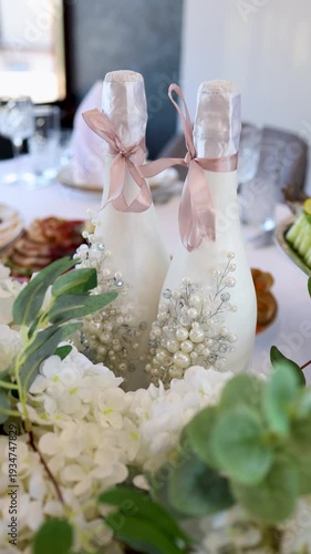 Decorated champagne bottles with pearls and ribbons