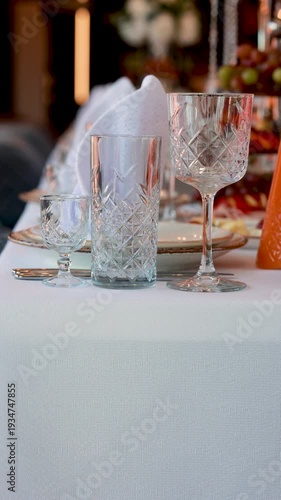 Crystal glassware place setting on white tablecloth