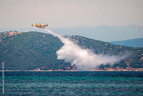 Fire fighter airplane during training throws water on small island.