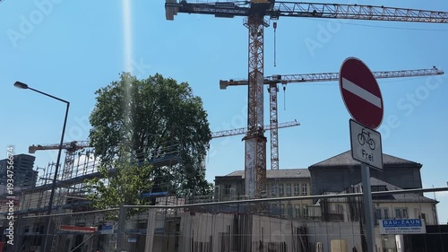 New building construction site with cranes in downtown of Cologne, Germany. Industry and real estate concept