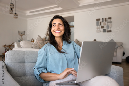 Fotografía Happy Brazilian woman using modern laptop at home, enjoy e-shopping, communicati