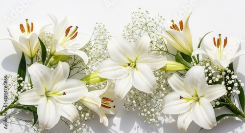 Delicate white lilies arranged with airy baby's breath on a bright surface