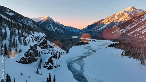 Wallpaper Mural A majestic snow-capped valley with a winding frozen river under a soft sunrise sky Torontodigital.ca