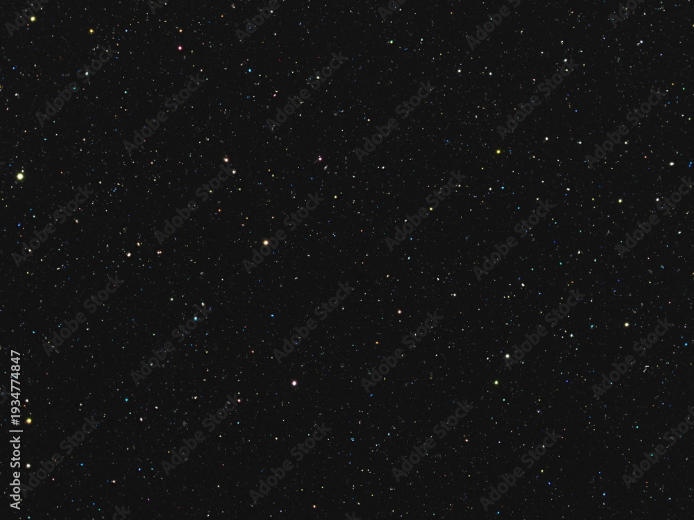 Obraz premium Macro photography of deep black background with sparse colorful starry sparkles