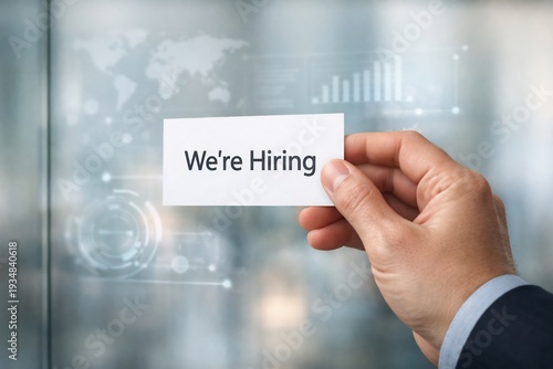 Wallpaper Mural Hand holding 'we're hiring' card in business setting with blurred background Torontodigital.ca