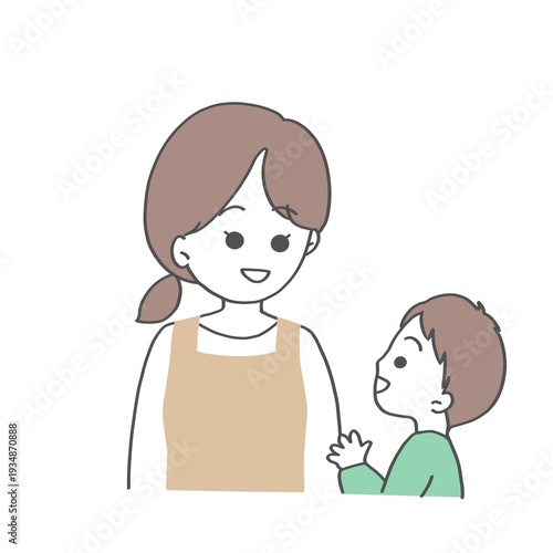 笑顔でこどもと話すエプロン姿の女性
