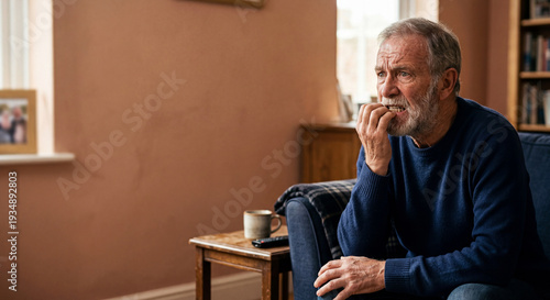 Senior man biting nails expressing worry and anxiety