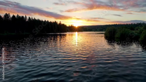 Sunset natural scenery in the lakeside forest, the tranquil beauty of sunset on the lake