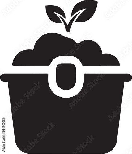 Black compost bin with green sprout growing out