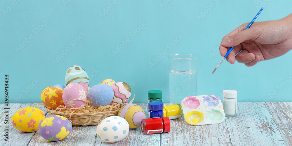 Fototapeta premium Easter egg decorating with vibrant colors and artistic tools