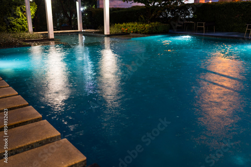 Wallpaper Mural Rainy day at the pool at night, Rain drops in a pool Torontodigital.ca