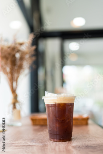 Wallpaper Mural Iced Americano in a take out togo cup on table Torontodigital.ca