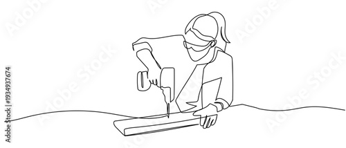 One continuous line outline of a female carpenter using a drill to bore holes in a piece of wood. Editable stroke.