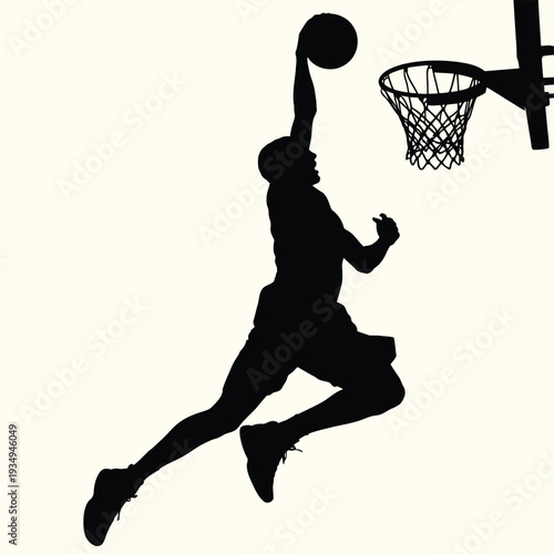 Silhouette of a basketball player in mid air about to dunk