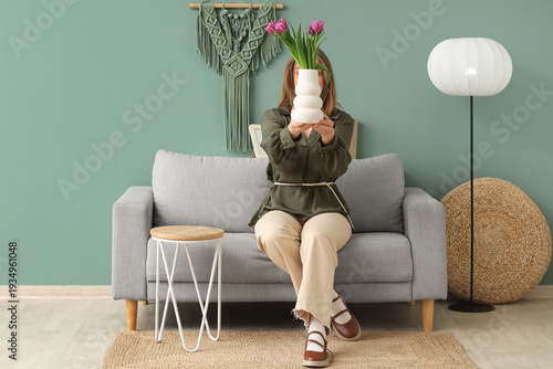Young woman with tulips sit...