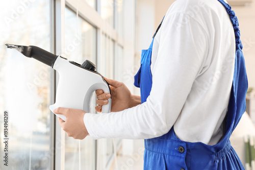 Female janitor with steam c...