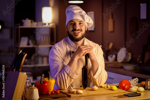 Male chef with knife cuttin...