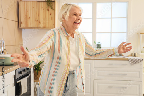 Portrait of happy senior woman in kitchen