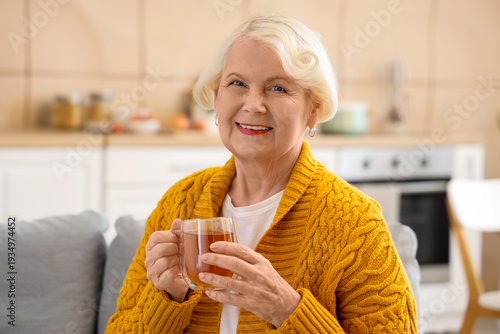 Senior woman with cup of te...