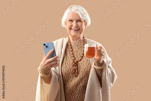 Senior woman with cup of te...