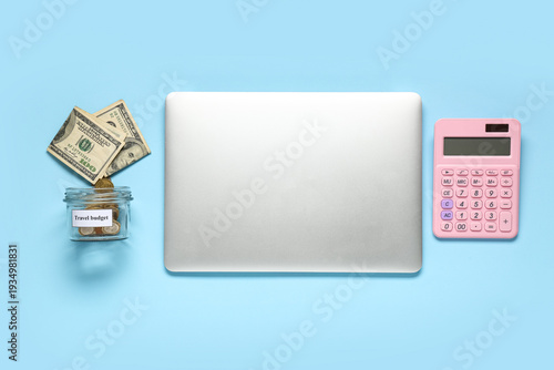 Laptop with money jar and c...