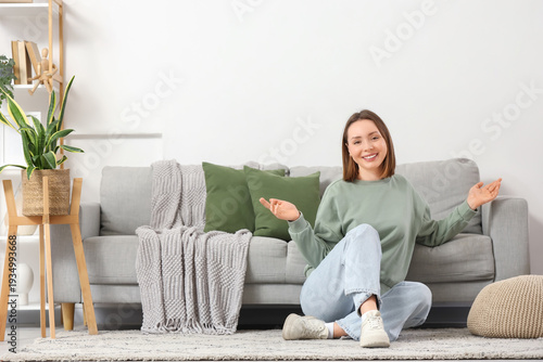 Happy young woman sitting o...