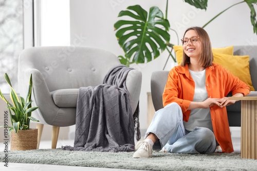 Happy young woman sitting o...