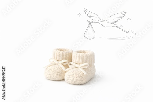 Knitted baby booties with stork carrying bundle doodle on clean white background, newborn announcement concept, copy space