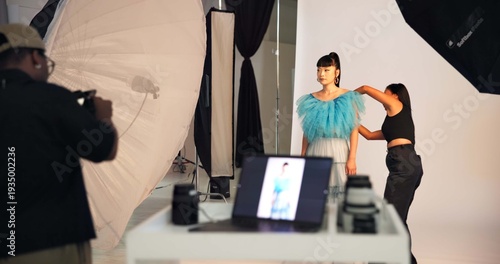 Fotografie Preparation, photoshoot and people on set with stylist, getting ready and clothing option in studio