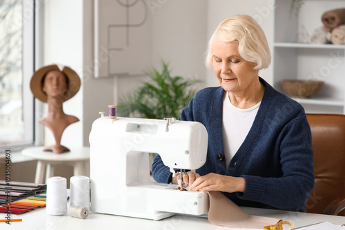 Senior female tailor sewing...
