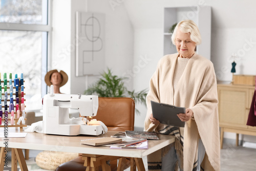 Senior female tailor with c...