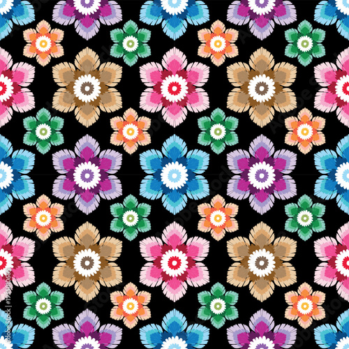 Bold seamless floral pattern featuring layered daisy-like blossoms in vivid multicolor palette on black background. Perfect for fabric, apparel prints, home decor, and creative packaging.