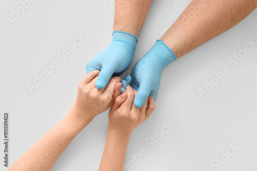 Doctor with patient holding...