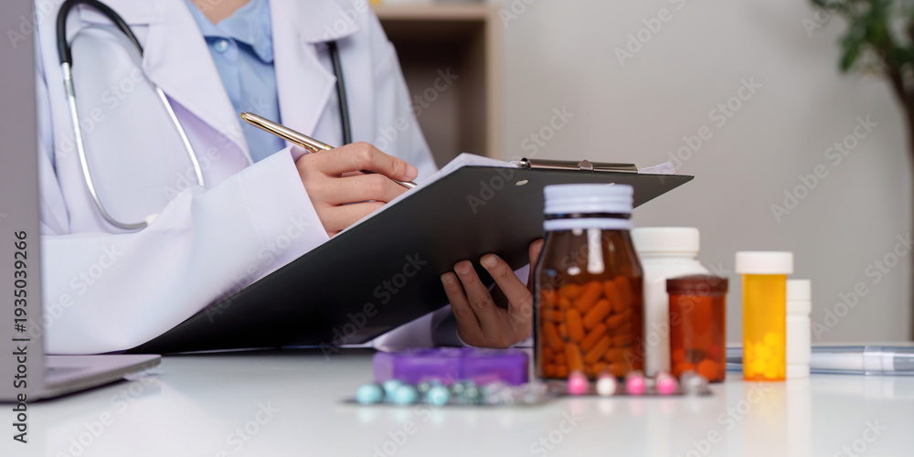Fototapeta premium Doctor reviewing patient medications and health summary