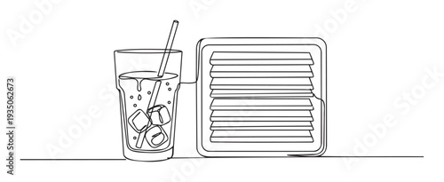 A refreshing iced beverage with a straw and three ice cubes sits next to a perfectly grilled sandwich, perfect for menu designs, food advertisements, or culinary promotions.