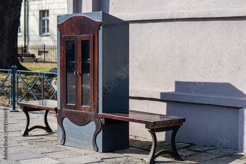 Photos Original outdoor street library in vintage cabinet style with benches, urban sma