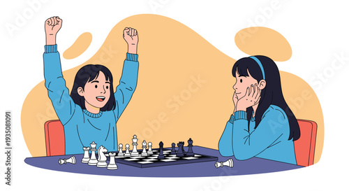 Two young girls sitting at a table and playing a competitive game of chess with one girl cheering after making a successful winning move.