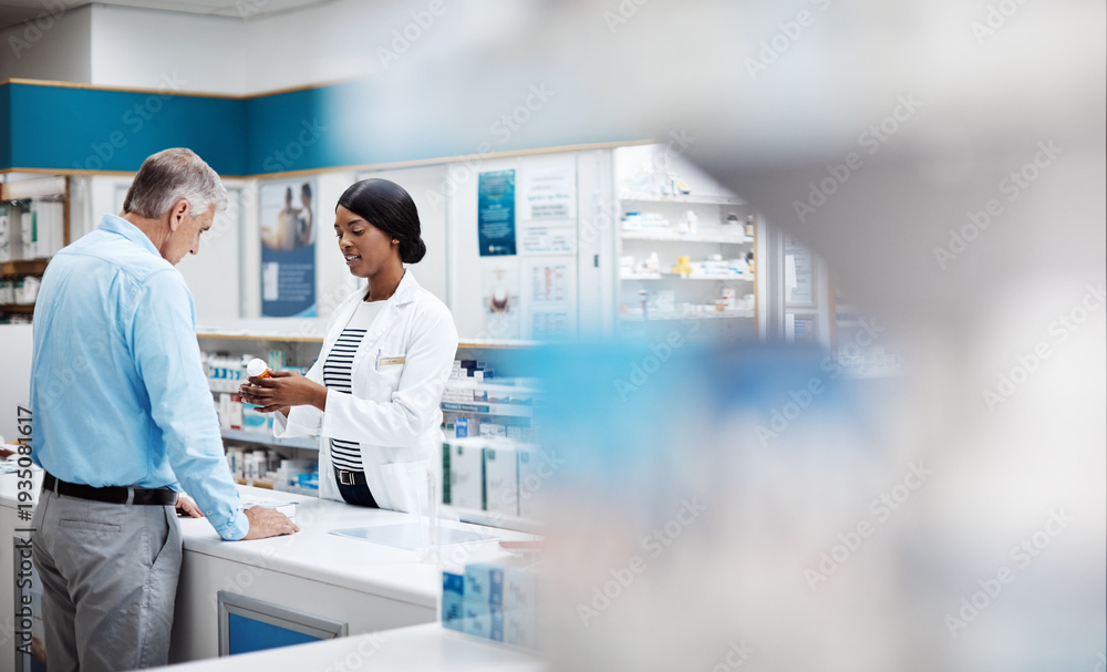 Obraz premium Medication, helping and pharmacist with man by dispensary for prescription pills for wellness. Discussion, medicine and healthcare worker with mature male patient for tablets in drugstore chemist.