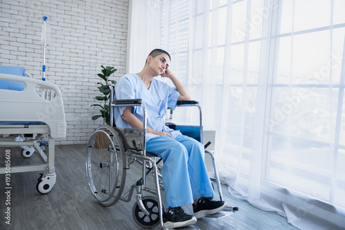 Patient Caucasian woman sitting in wheel chair in hospital ward and front of window