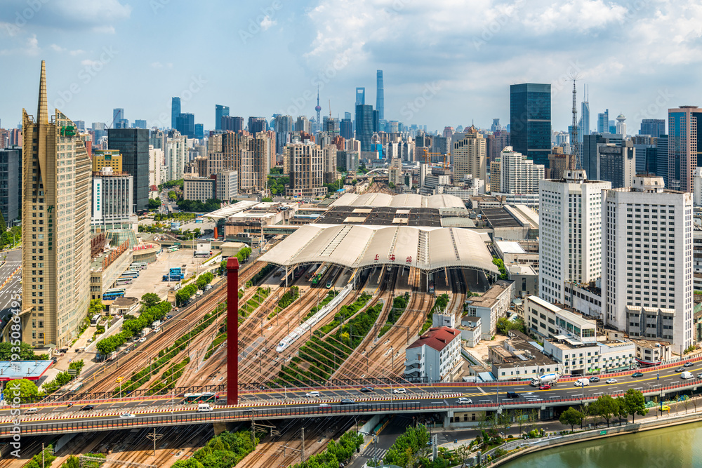 Fototapeta premium Shanghai Railway Station with Urban Cityscape and Transportation Infrastructure