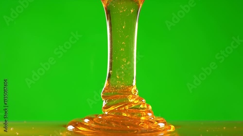 Golden Honey Dripping in Smooth Stream on Green Screen Background