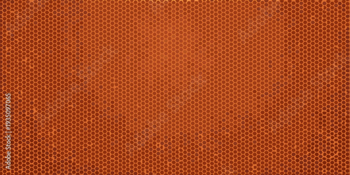 Close up of an orange basketball s textured surface with repeating patterns