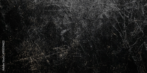 A dark wall textured background featuring intricate patterns of scratches and subtle variations in grayscale tones