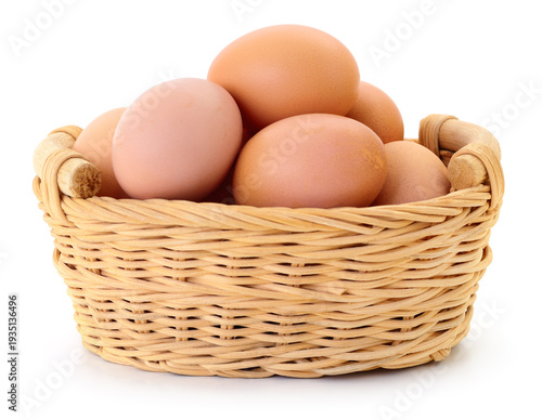 Wallpaper Mural Brown chicken eggs in a small wicker basket isolated on white background Torontodigital.ca