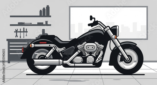 Black cruiser motorcycle parked in a garage workshop.