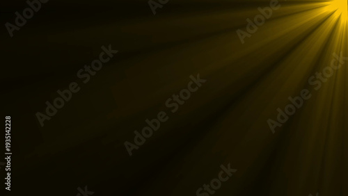 Golden yellow light rays emanating from the right corner against a dark background creating a warm atmospheric effect