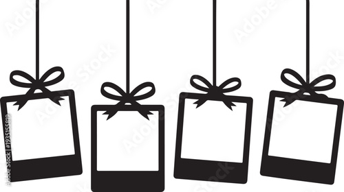 Four blank photo frames with ribbons hanging on strings for decoration