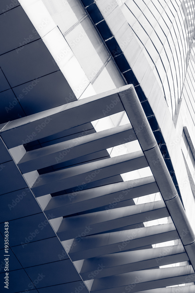 Obraz premium Metal louvers angling across modern facade in upward perspective